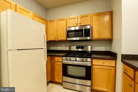 a kitchen with a stove microwave and refrigerator