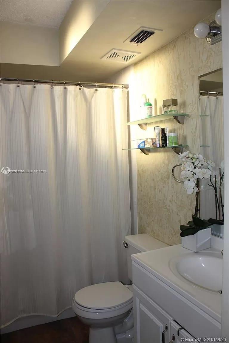 1010 Northwest 11th Street, Unit 601 Miami, FL 33136 - Photo 11 of 35 a bathroom with a sink a toilet and shower