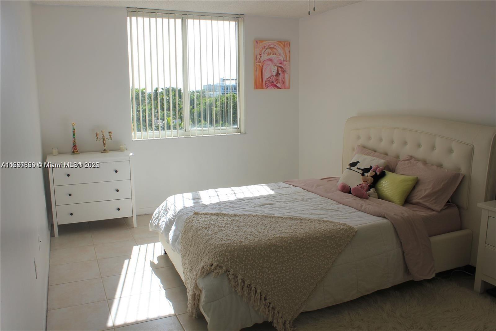 1010 Northwest 11th Street, Unit 601 Miami, FL 33136 - Photo 12 of 35 a bedroom with a bed and a window
