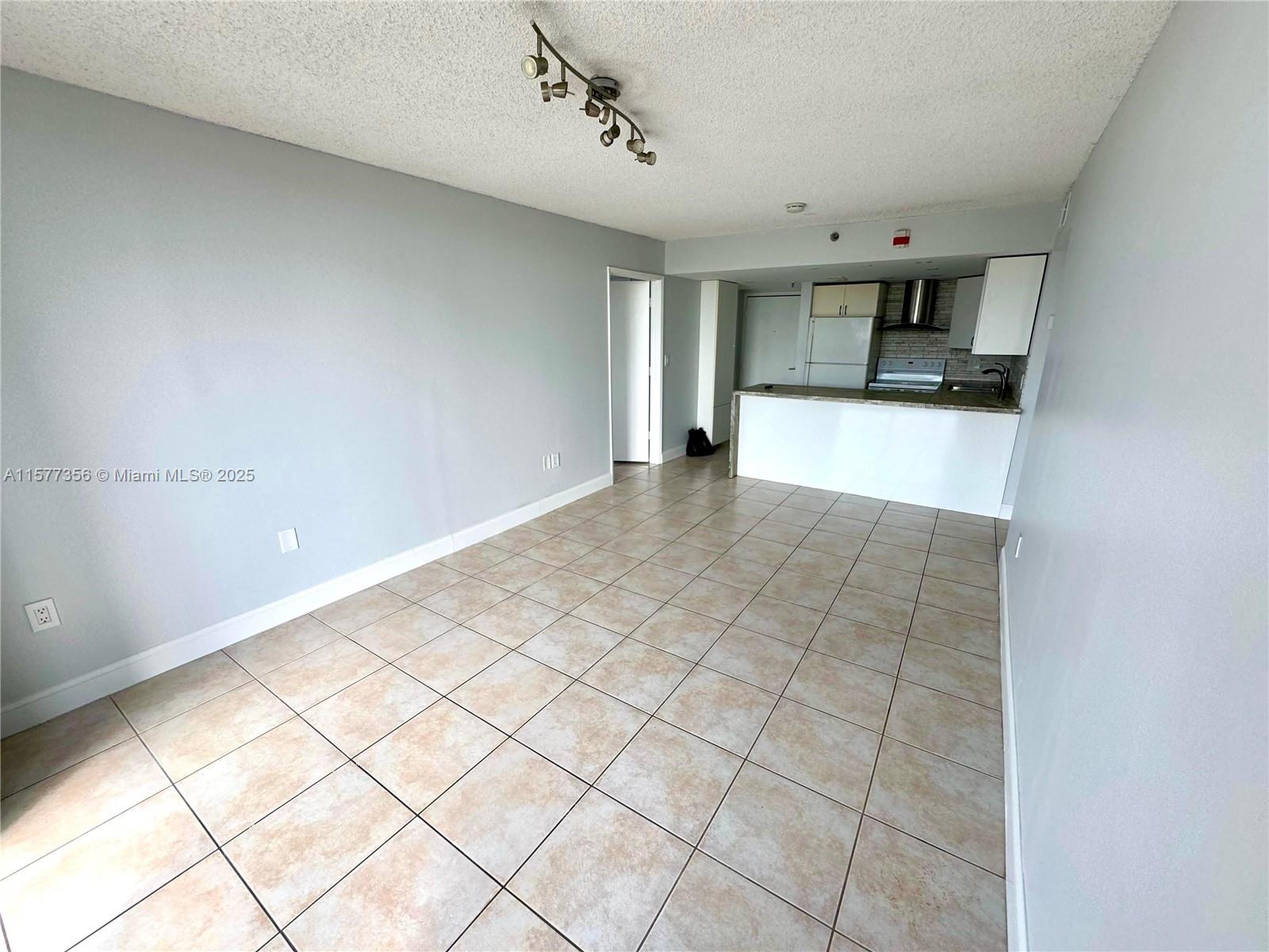1010 Northwest 11th Street, Unit 601 Miami, FL 33136 - Photo 29 of 35 a view of a kitchen with wooden floor and a window