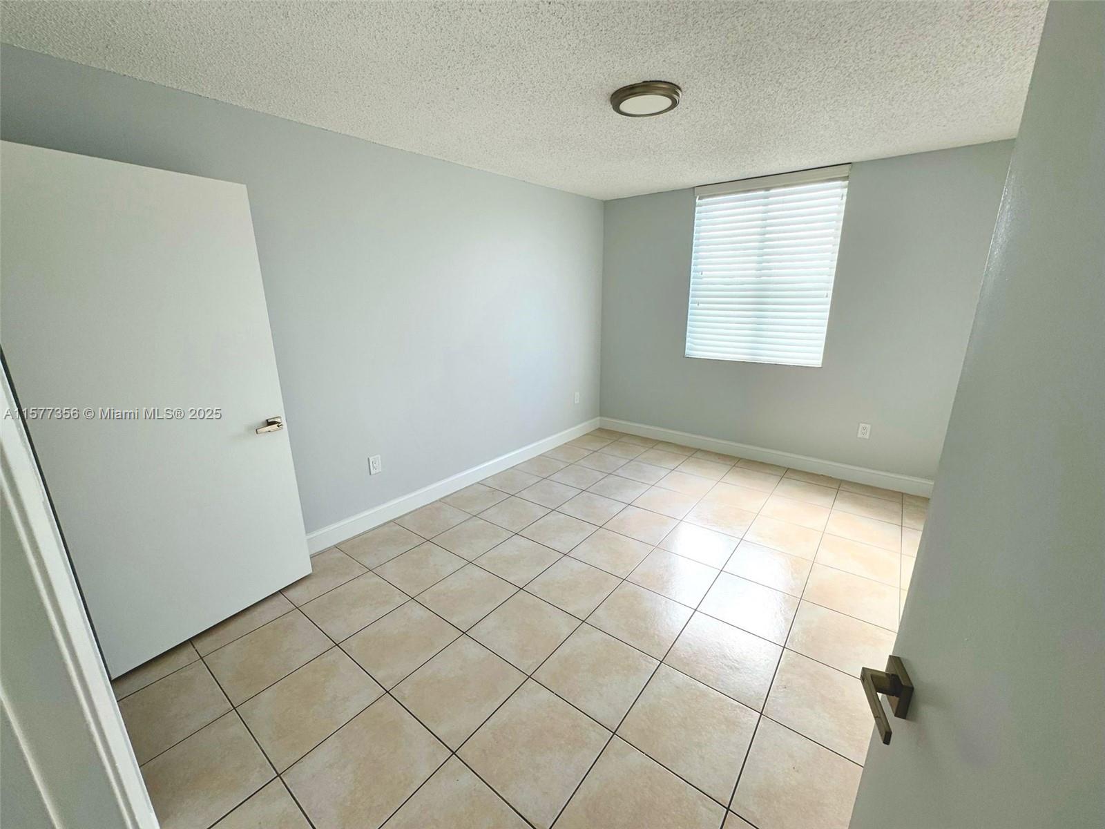 1010 Northwest 11th Street, Unit 601 Miami, FL 33136 - Photo 31 of 35 an empty room with windows