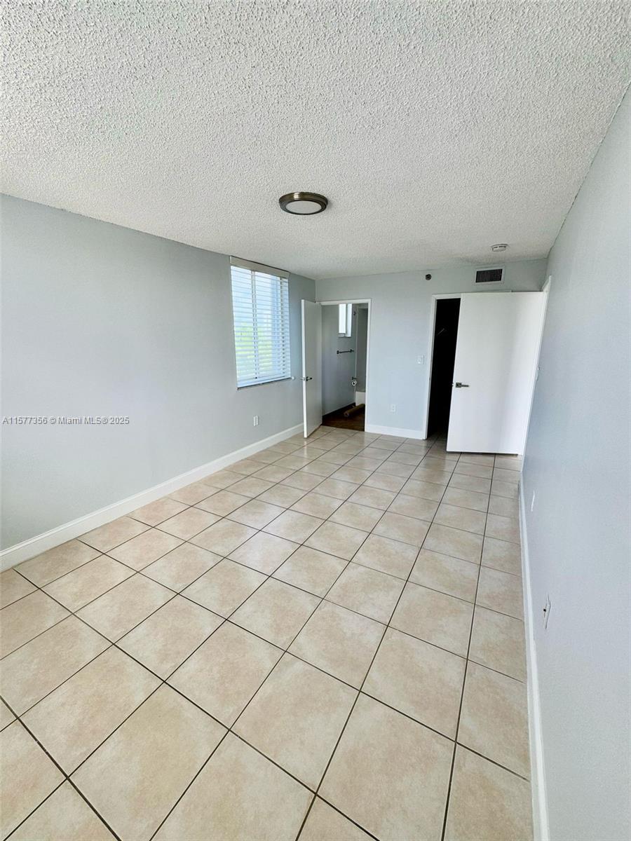 1010 Northwest 11th Street, Unit 601 Miami, FL 33136 - Photo 34 of 35 a view of a livingroom with an empty space and a window