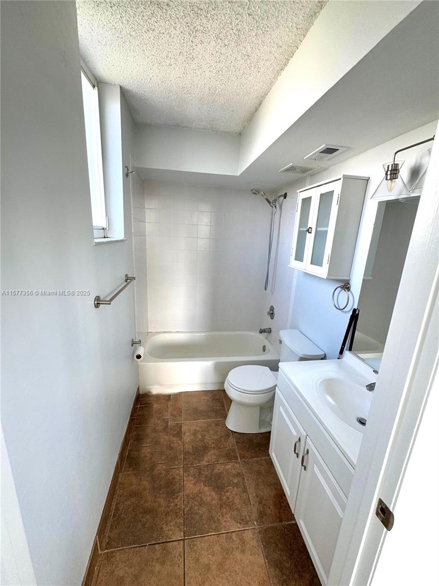 1010 Northwest 11th Street, Unit 601 Miami, FL 33136 - Photo 35 of 35 a bathroom with a sink a toilet and shower