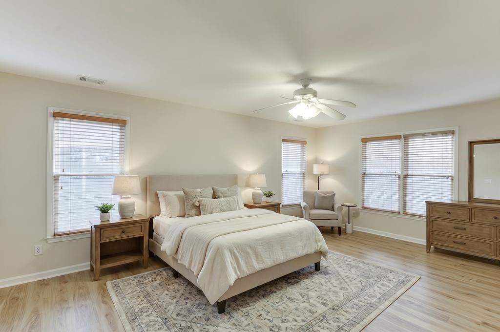 1830 Sanborne Way Dacula, GA 30019 - Photo 13 of 33 a bedroom with a large bed and a chandelier