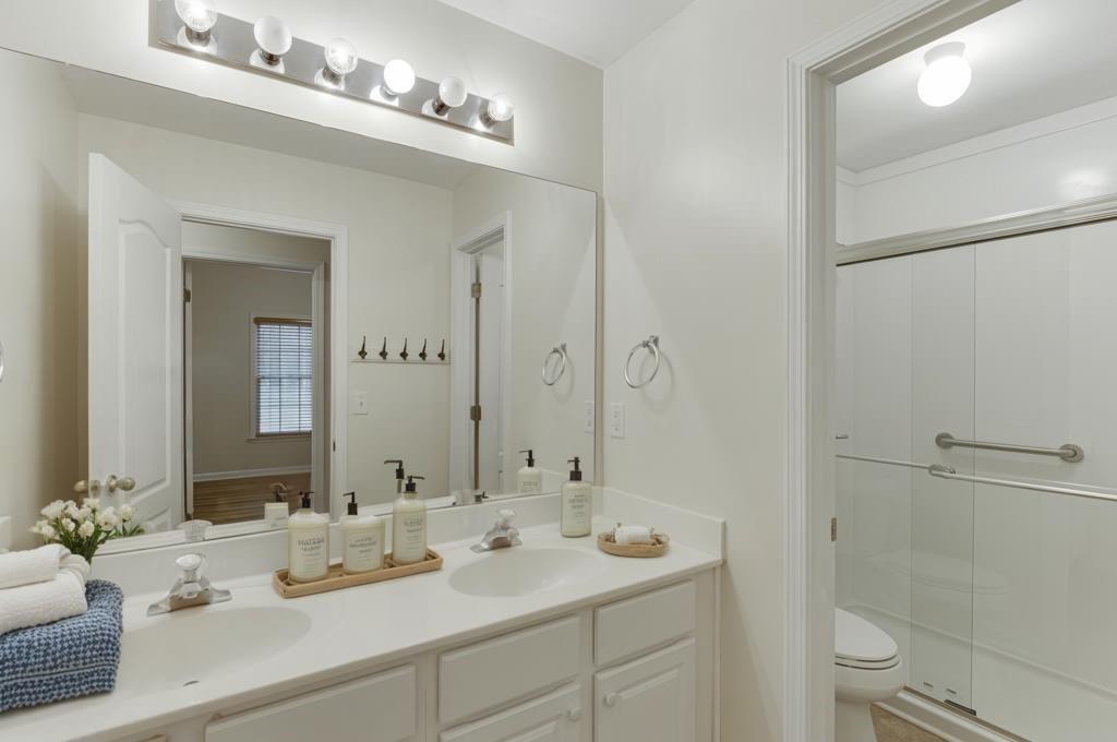1830 Sanborne Way Dacula, GA 30019 - Photo 14 of 33 a bathroom with a double vanity sink mirror and toilet