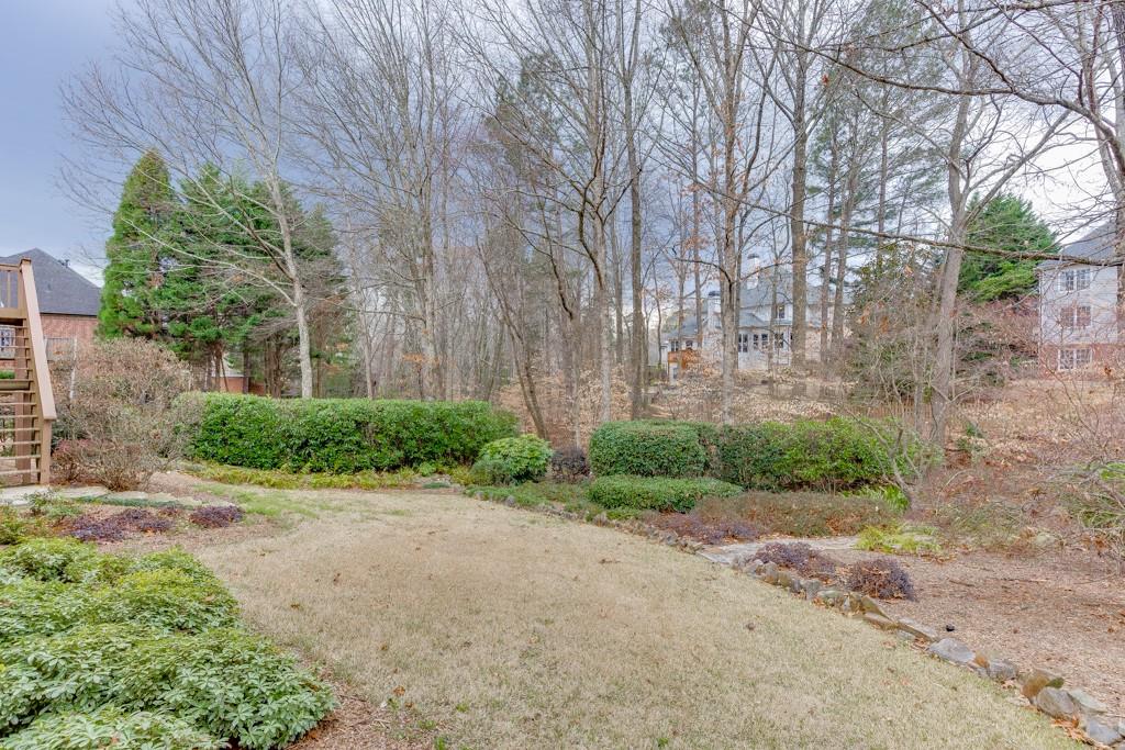 1830 Sanborne Way Dacula, GA 30019 - Photo 26 of 33 a view of a garden with plants and large trees