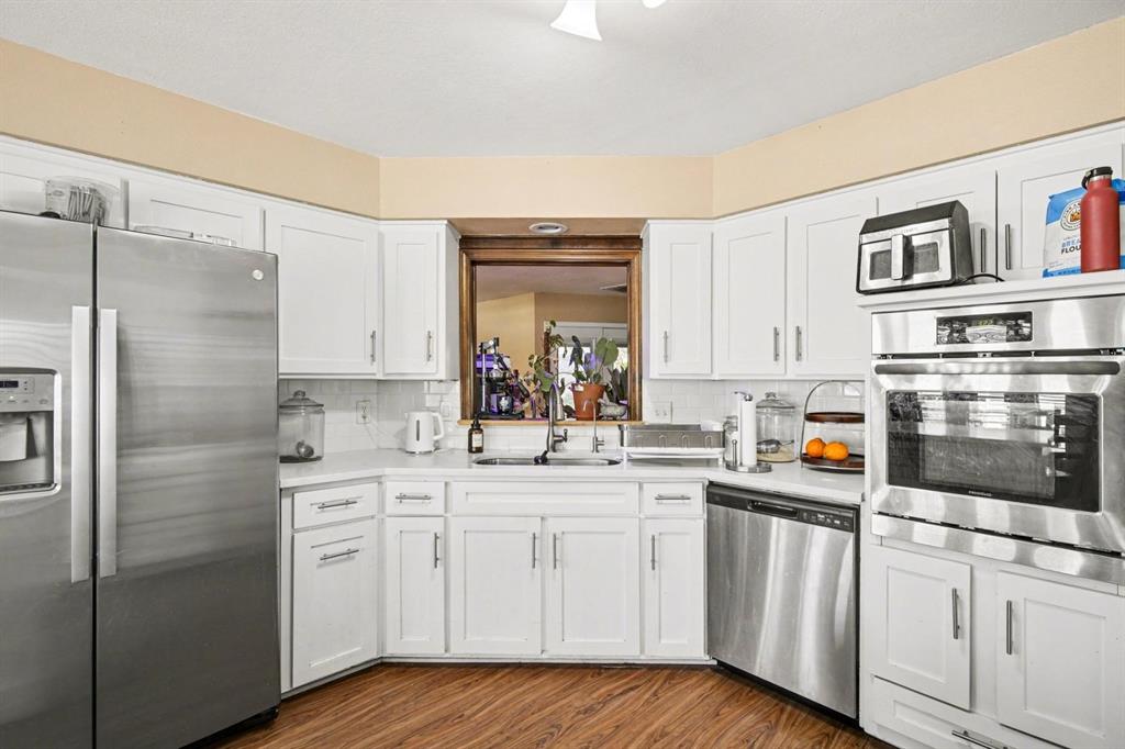 5009 River Ridge Road Arlington, TX 76017 - Photo 12 of 28 a kitchen with stainless steel appliances a sink stove and refrigerator