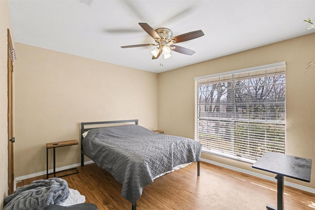 5009 River Ridge Road Arlington, TX 76017 - Photo 23 of 28 a bedroom with a bed and window