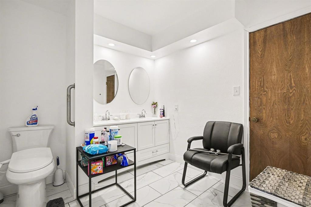5009 River Ridge Road Arlington, TX 76017 - Photo 24 of 28 a very nice looking room with a chair and white walls