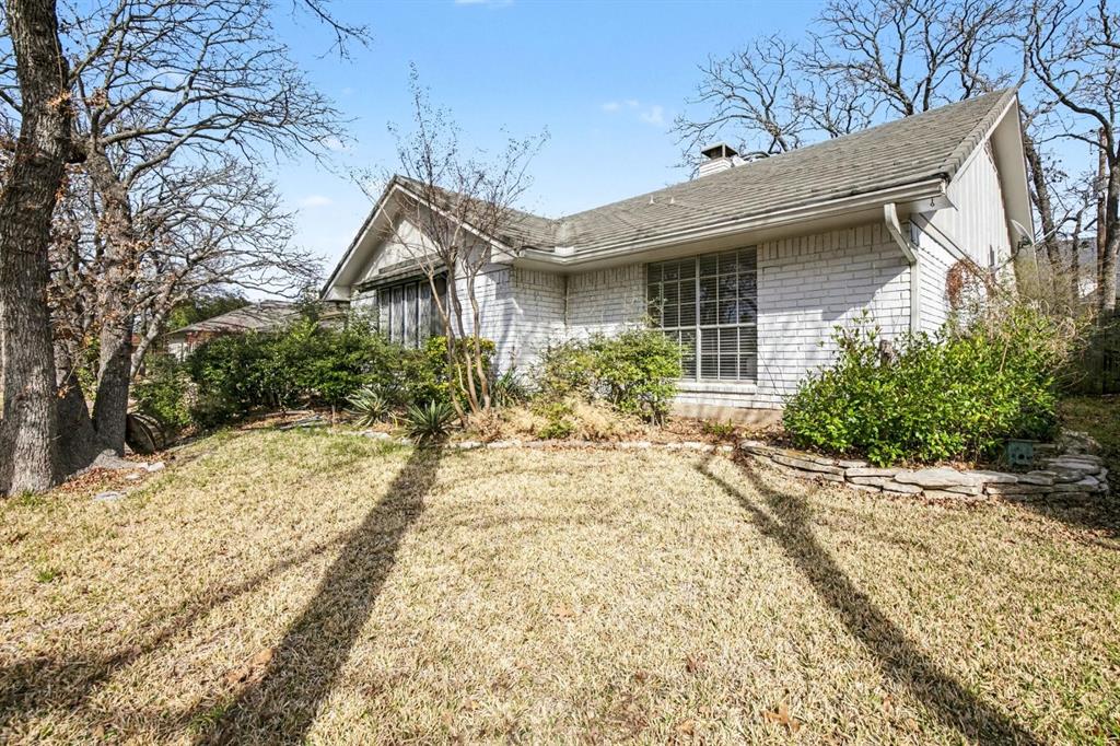 5009 River Ridge Road Arlington, TX 76017 - Photo 4 of 28 a front view of a house with a yard and garage