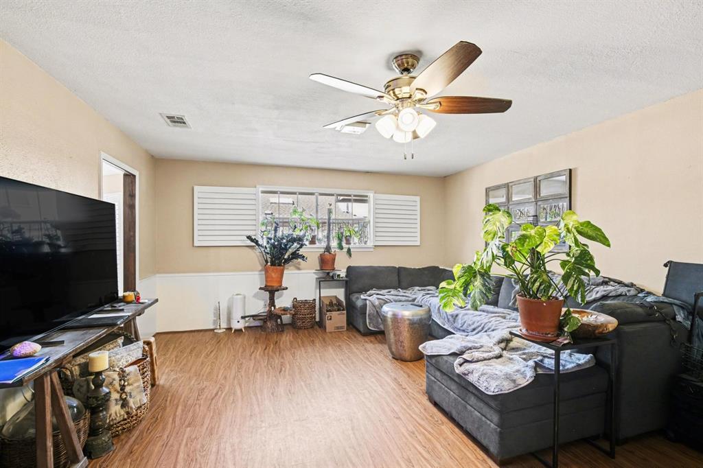 5009 River Ridge Road Arlington, TX 76017 - Photo 7 of 28 a living room with furniture and a flat screen tv
