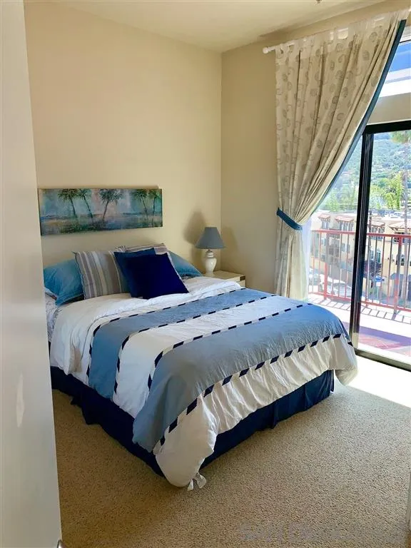 2130 Vallecitos, Unit 441 La Jolla, CA 92037 - Photo 15 of 25 a bedroom with a bed and window