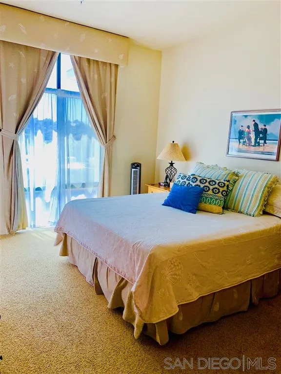 2130 Vallecitos, Unit 441 La Jolla, CA 92037 - Photo 20 of 25 a bedroom with a bed and a painting on the wall