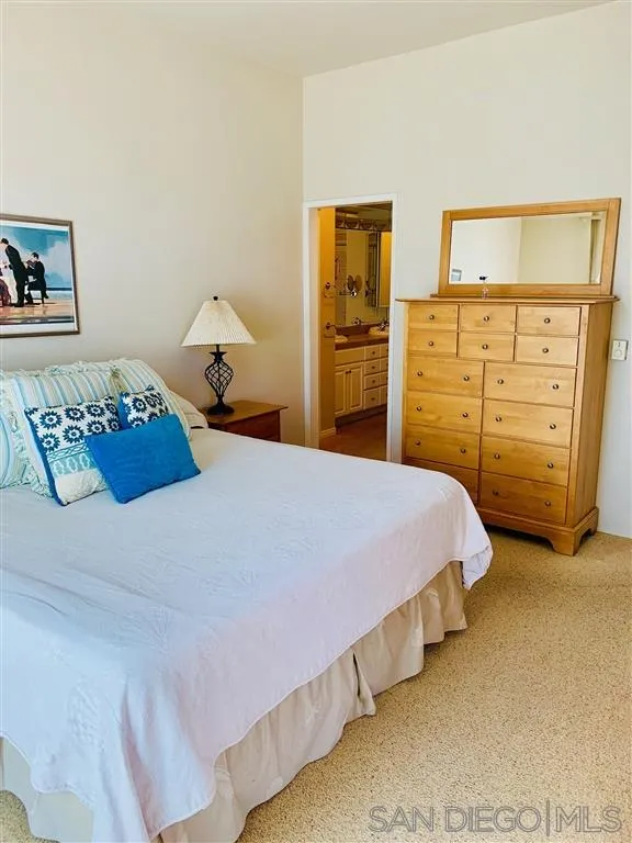 2130 Vallecitos, Unit 441 La Jolla, CA 92037 - Photo 21 of 25 a bedroom with a bed and dresser