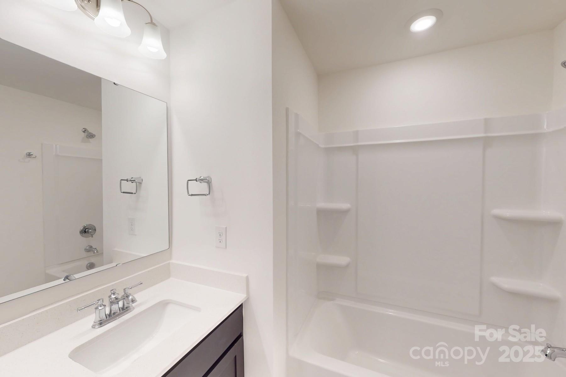 1030 Overbrook Place Wingate, NC 28174 - Photo 15 of 21 a bathroom with a bathtub shower sink vanity and a toilet