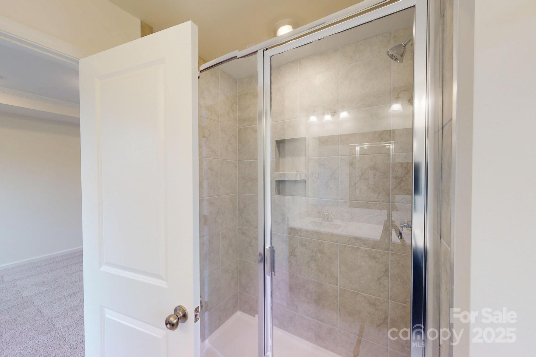 1030 Overbrook Place Wingate, NC 28174 - Photo 21 of 21 a bathroom with a glass shower door
