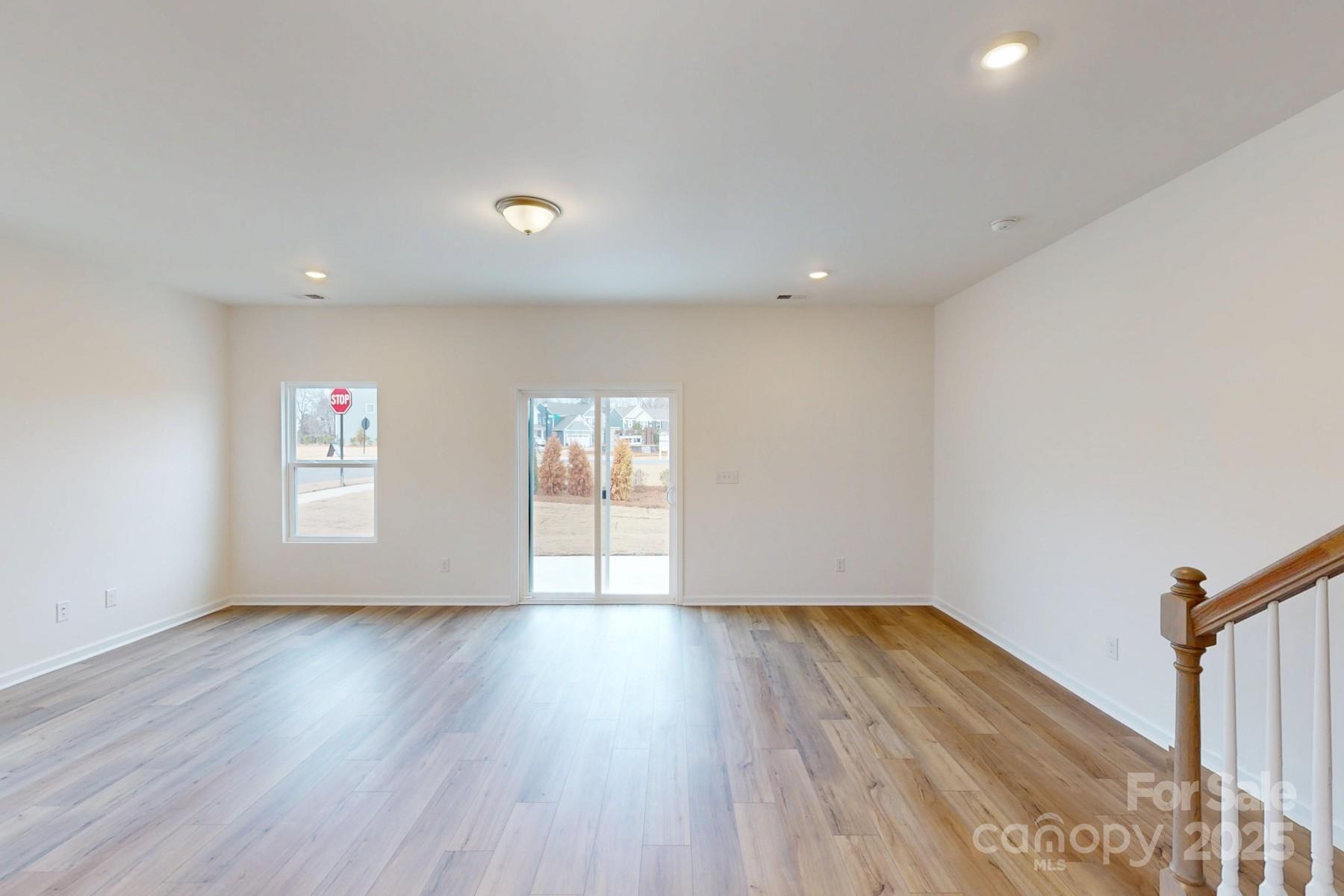1030 Overbrook Place Wingate, NC 28174 - Photo 7 of 21 a view of an empty room with wooden floor and a window