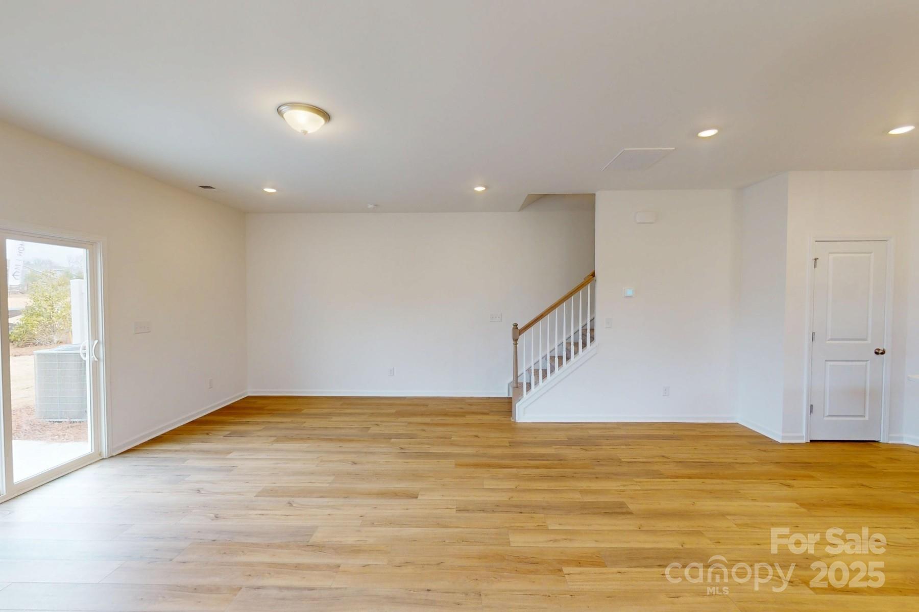 1030 Overbrook Place Wingate, NC 28174 - Photo 8 of 21 a view of an empty room with wooden floor