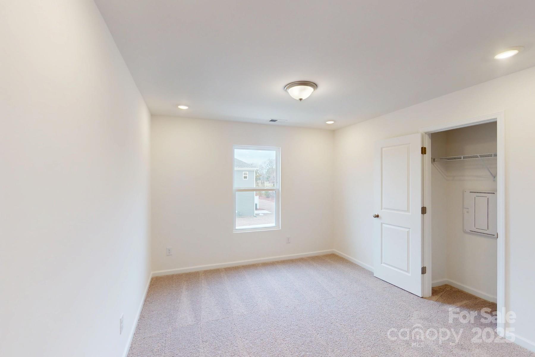 1030 Overbrook Place Wingate, NC 28174 - Photo 10 of 21 an empty room with windows and closet