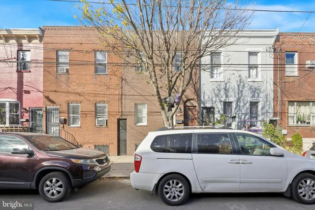 a view of a car parked in front of a house