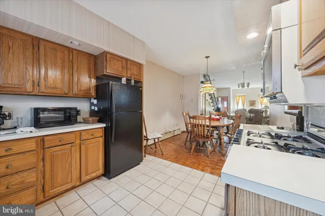 a kitchen with stainless steel appliances granite countertop a refrigerator and a stove top oven