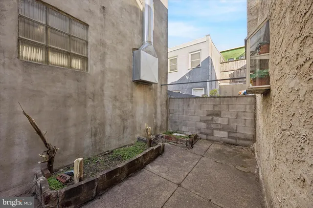 a view of a brick house with a small yard