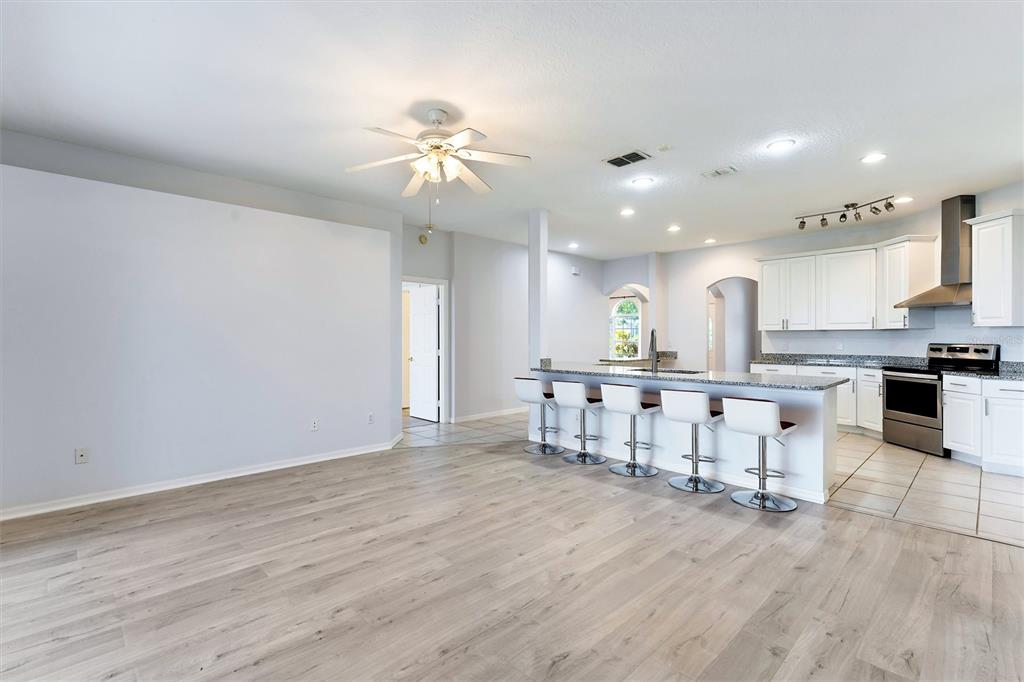 3984 Beacon Ridge Way Clermont, FL 34711 - Photo 21 of 59 Family Room/Kitchen w/view of entrance to Primary Bedroom