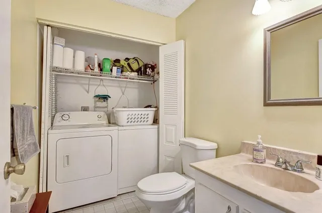 a bathroom with a sink a toilet and a mirror