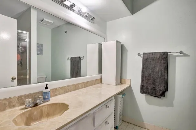 a spacious bathroom with a double vanity sink and a mirror