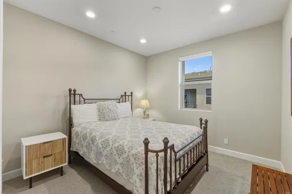 a bedroom with a bed and a night stand