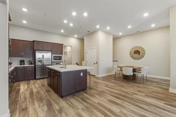 a kitchen with a table and chairs in it