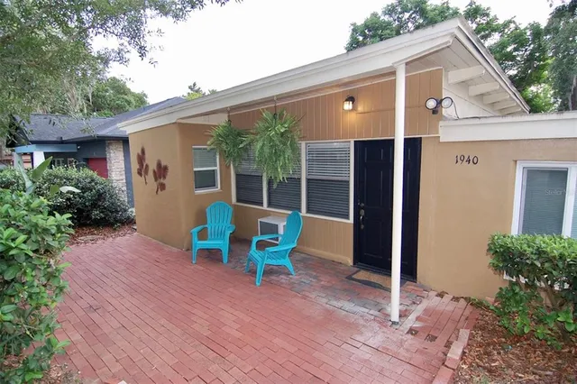 a view of house with a chairs and table in the patio