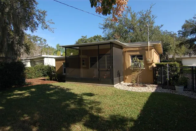 a view of a house with backyard and sitting area