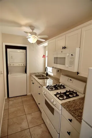 a kitchen with a stove a sink and a refrigerator
