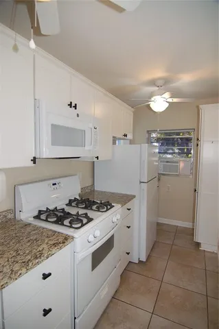 a kitchen with a stove a refrigerator and a sink