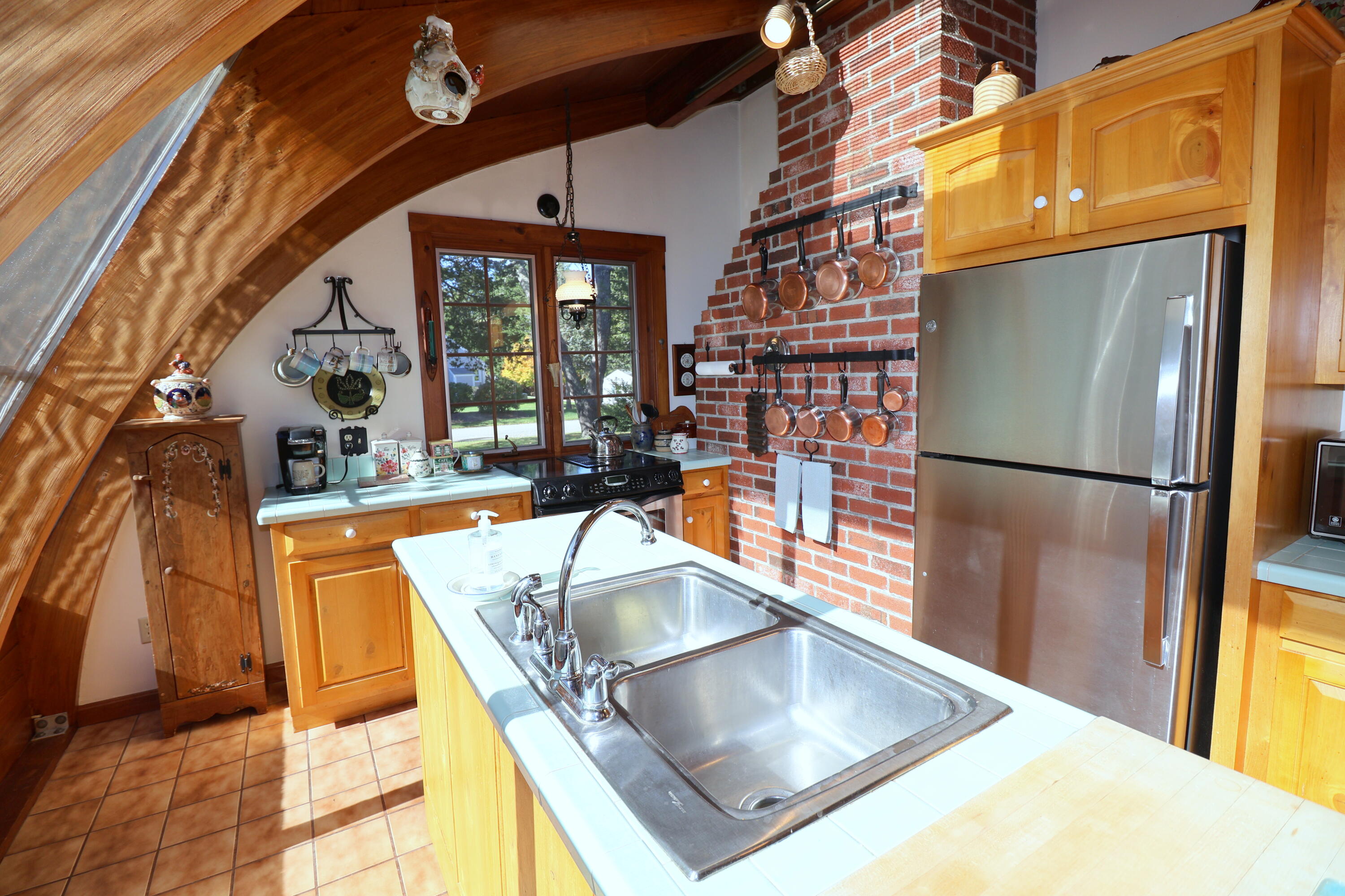42 Robbins Circle Dennis, MA 02638 - Photo 11 of 46 a kitchen with a refrigerator and a sink