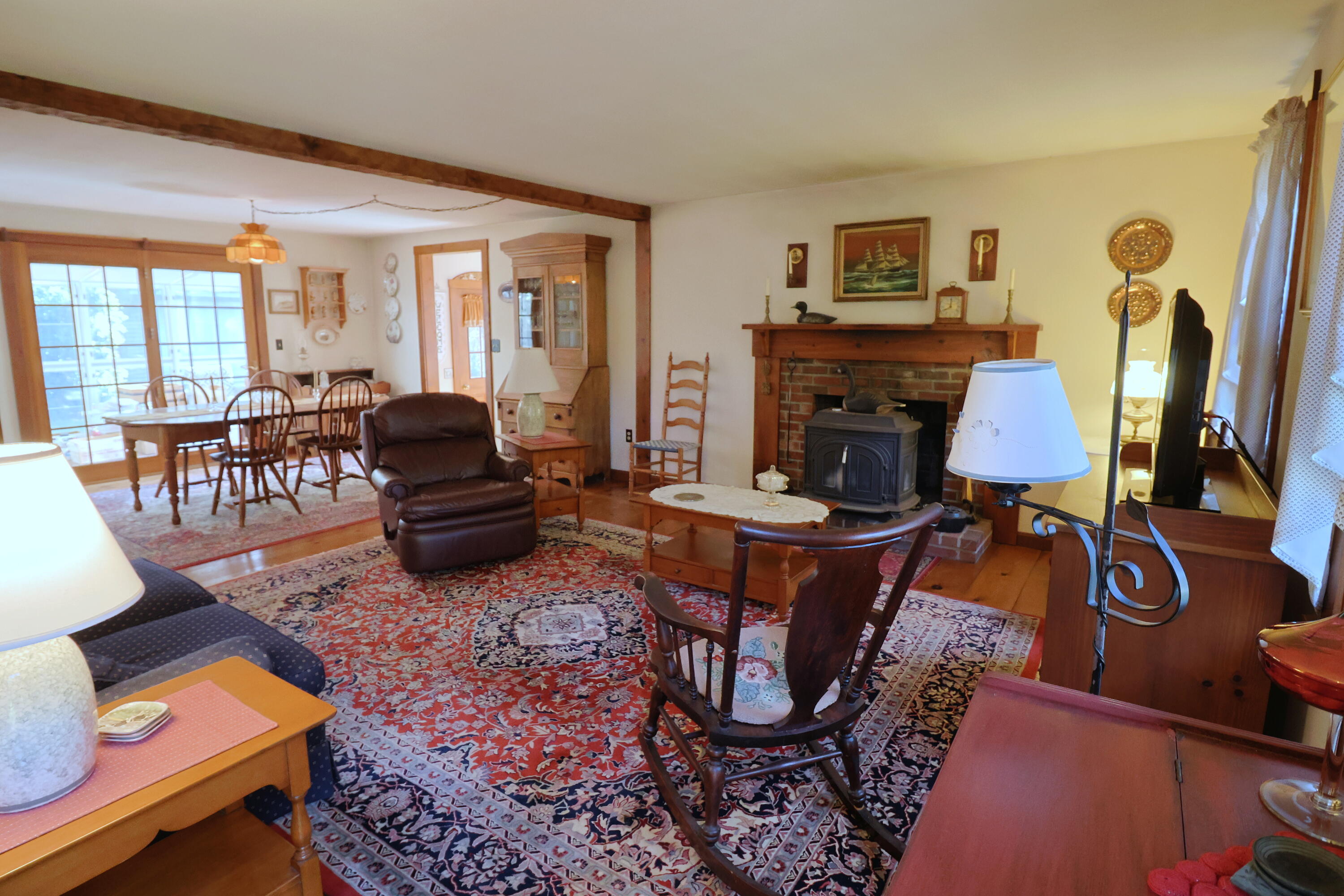 42 Robbins Circle Dennis, MA 02638 - Photo 3 of 46 a living room with furniture a rug and a floor to ceiling window