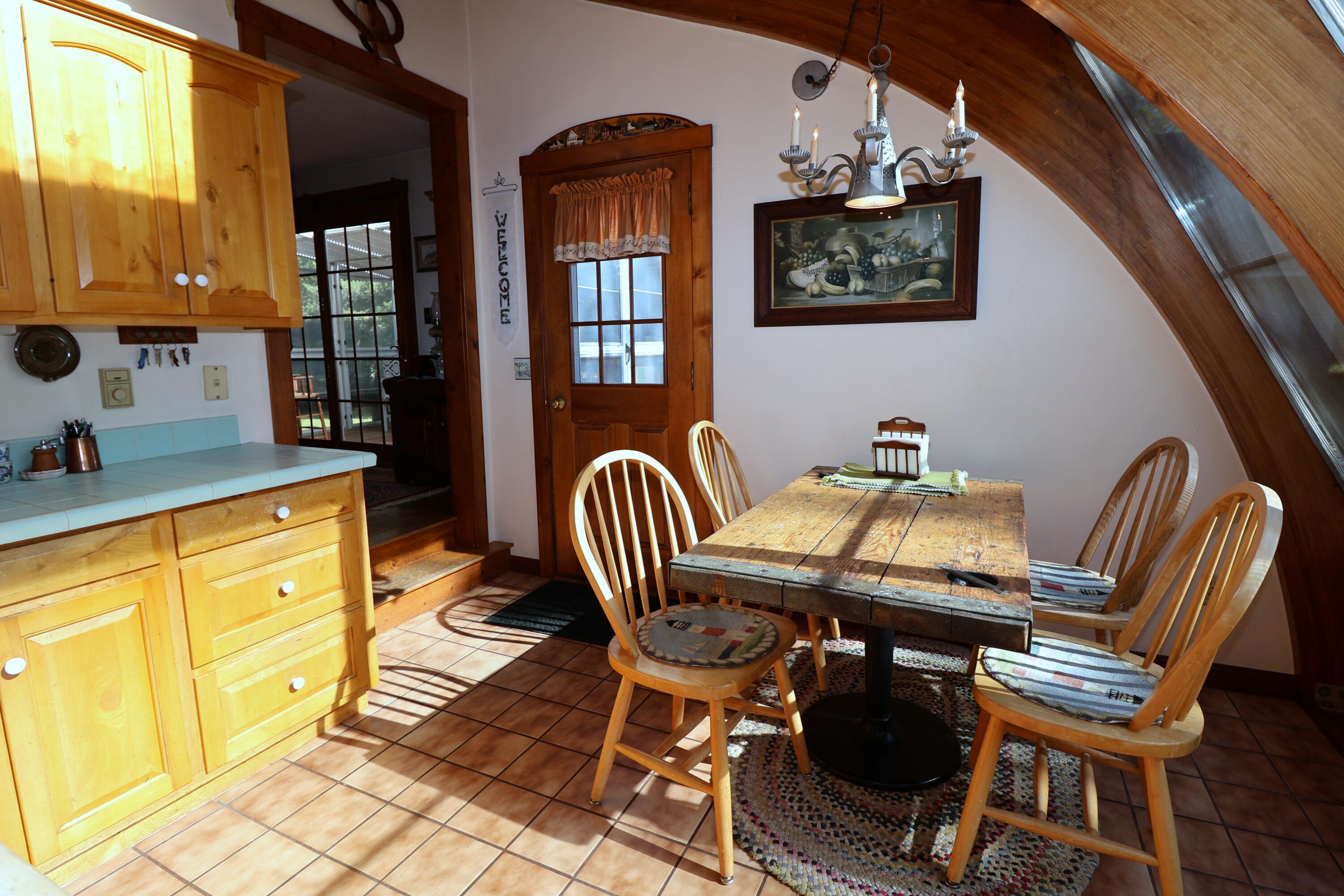 42 Robbins Circle Dennis, MA 02638 - Photo 9 of 46 a view of a dining room with furniture and chandelier