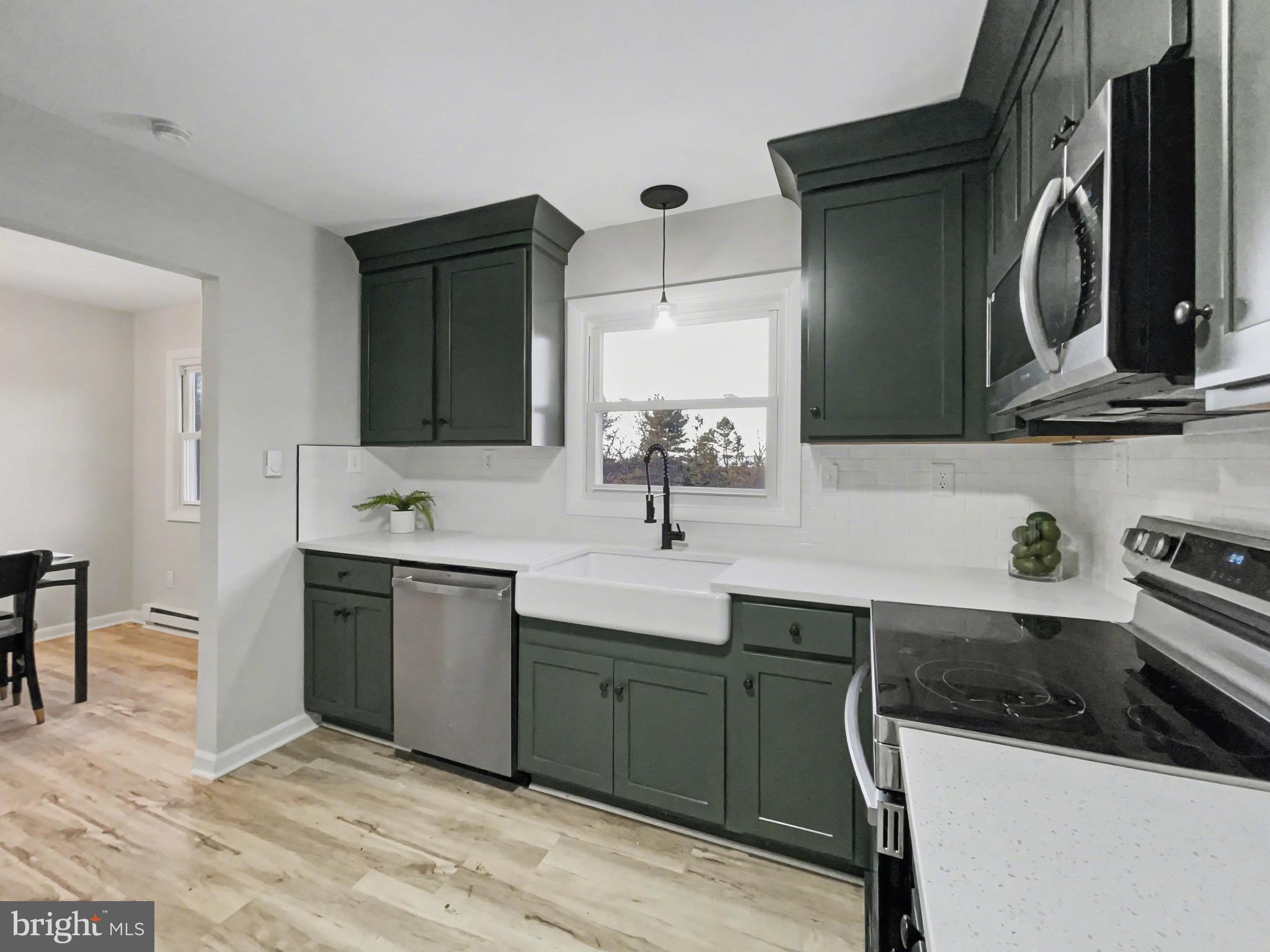 2206 Ridge Road Glenville, PA 17329 - Photo 9 of 23 a kitchen with a sink and a stove top oven with wooden floor