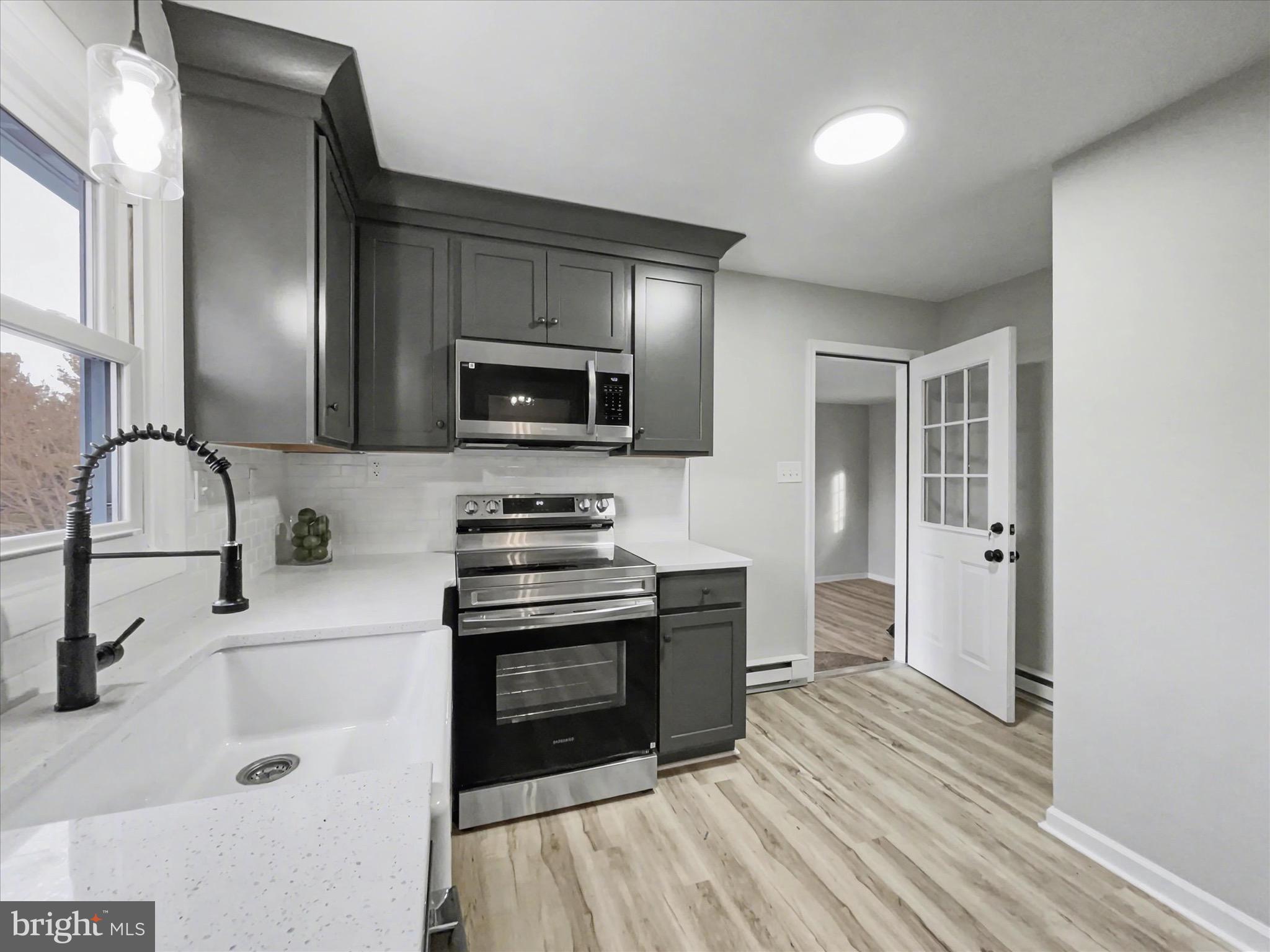 2206 Ridge Road Glenville, PA 17329 - Photo 10 of 23 a kitchen with stainless steel appliances a stove top oven a sink and a refrigerator