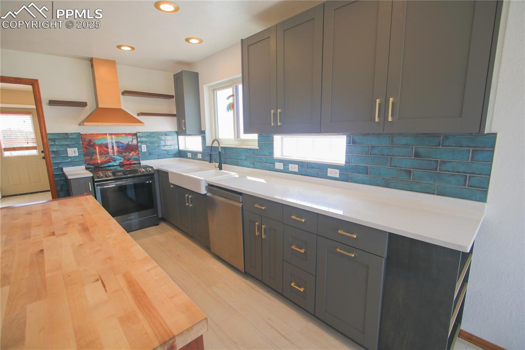 770 Cedar Hills Road Penrose, CO 81240 - Photo 11 of 49 a kitchen with stainless steel appliances kitchen island granite countertop a sink a stove counter space and cabinets