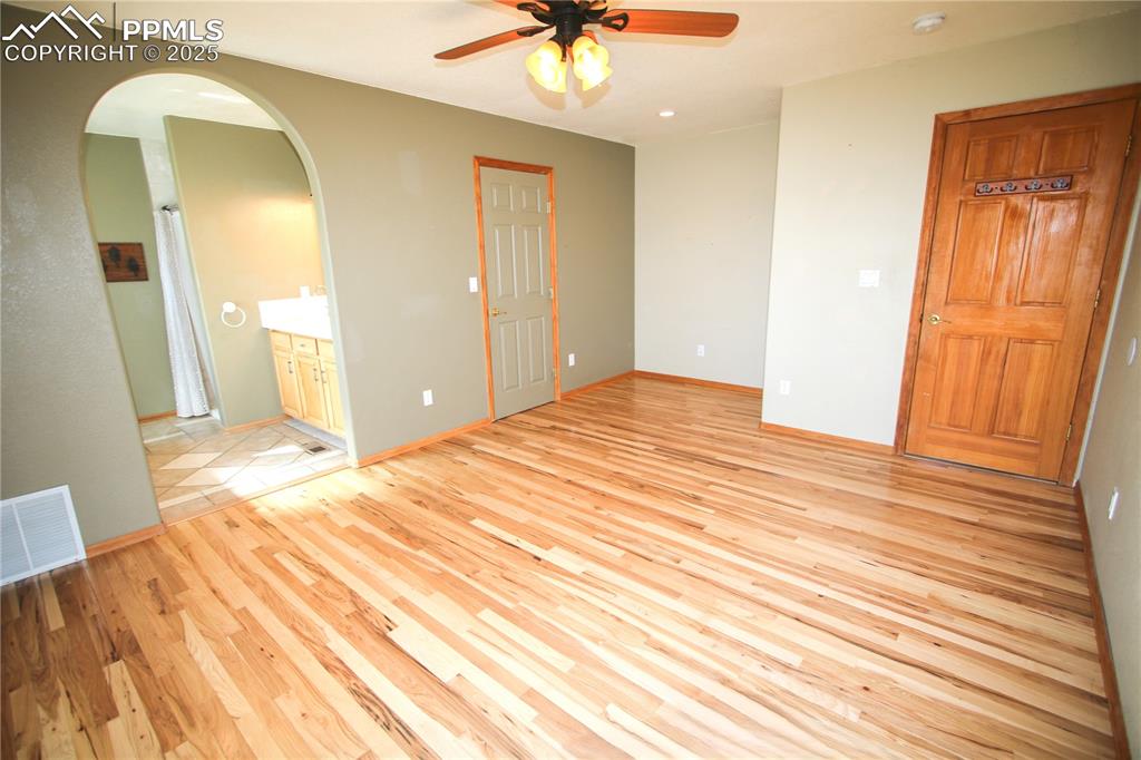 770 Cedar Hills Road Penrose, CO 81240 - Photo 16 of 49 a bedroom with a bed and a chandelier