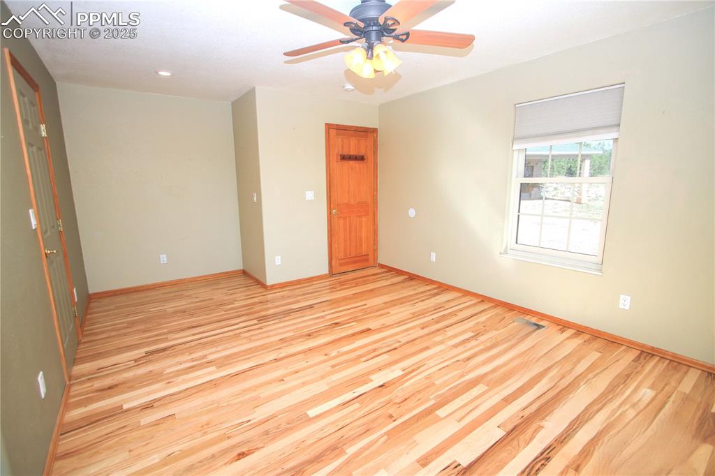 770 Cedar Hills Road Penrose, CO 81240 - Photo 17 of 49 an empty room with wooden floor closet and windows