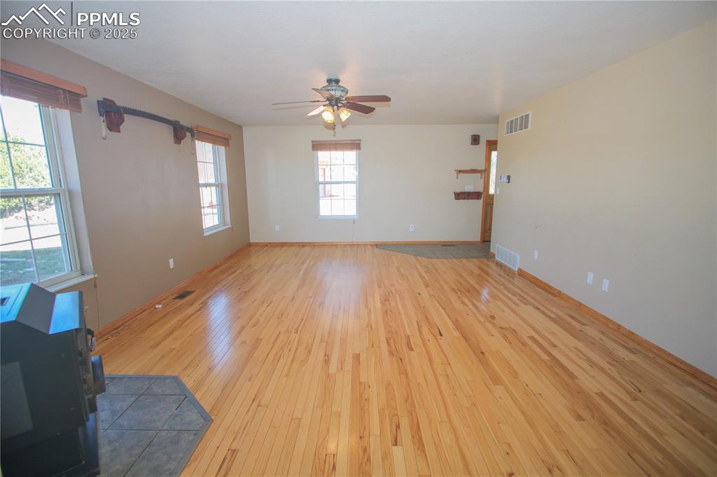 770 Cedar Hills Road Penrose, CO 81240 - Photo 7 of 49 a view of empty room with wooden floor and fan