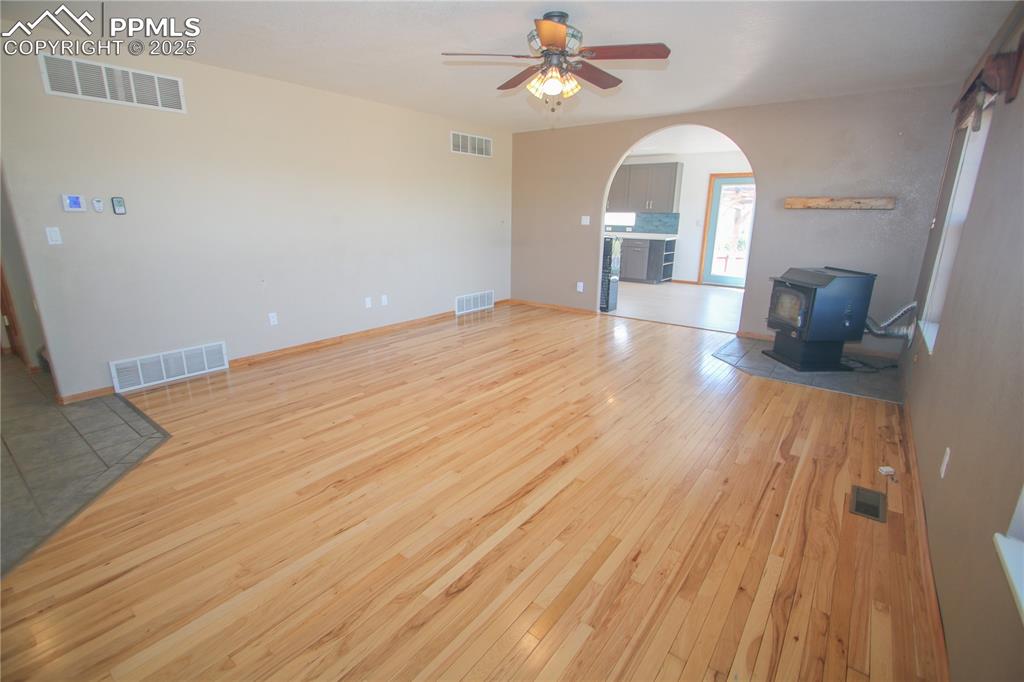 770 Cedar Hills Road Penrose, CO 81240 - Photo 8 of 49 a view of a livingroom with wooden floor a ceiling fan and staircase