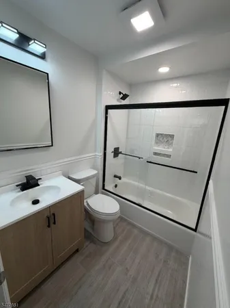 a spacious bathroom with a toilet a sink and mirror