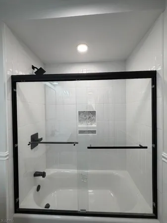 a bathroom with a shower and a bath tub