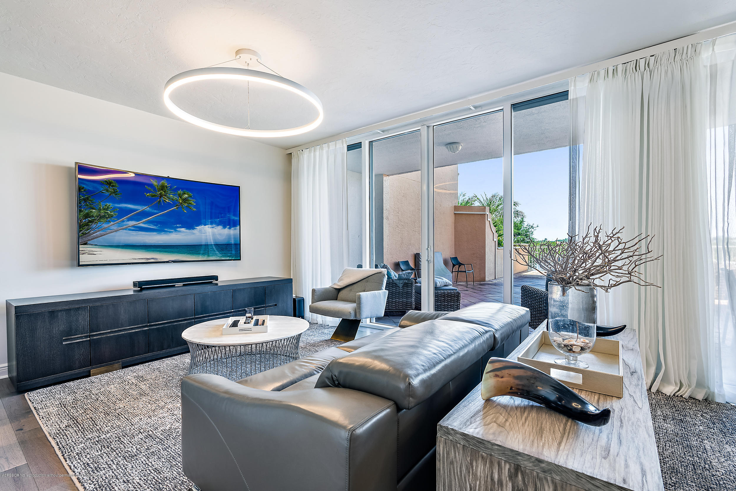 700 Highway 1, Unit 102 Jupiter, FL 33477 - Photo 11 of 36 a living room with furniture and a flat screen tv