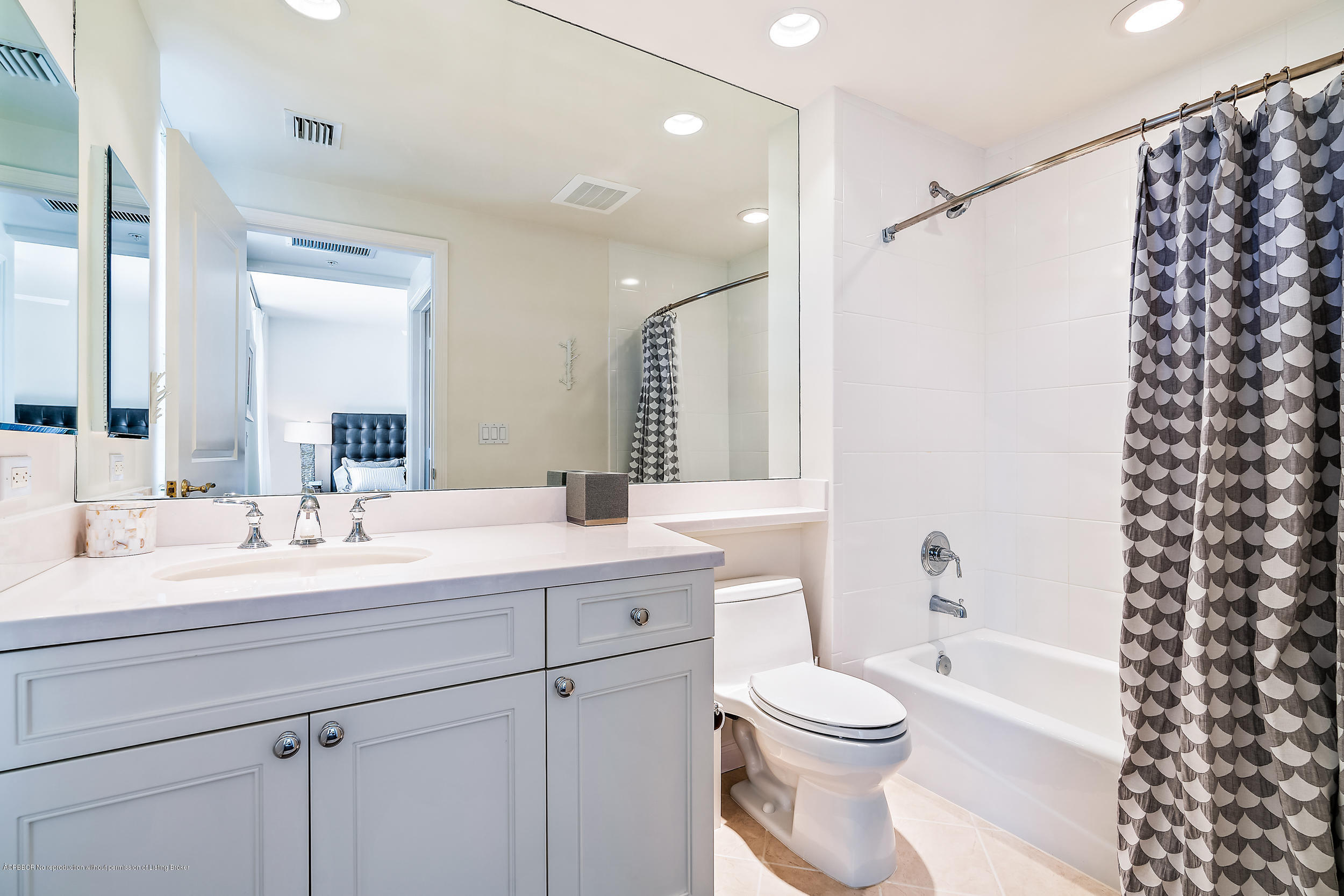 700 Highway 1, Unit 102 Jupiter, FL 33477 - Photo 28 of 36 a bathroom with a sink a toilet a mirror a vanity and shower