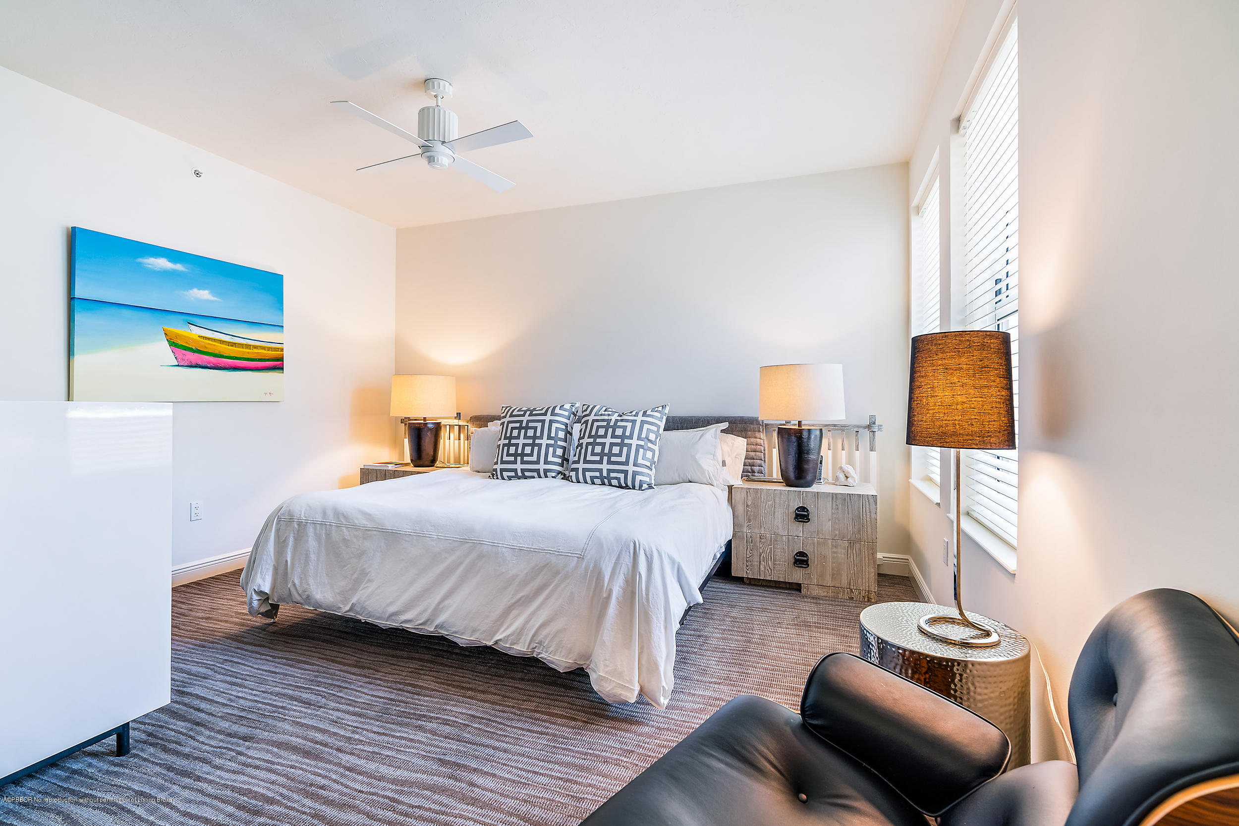 700 Highway 1, Unit 102 Jupiter, FL 33477 - Photo 29 of 36 a bedroom with a bed and wooden floor